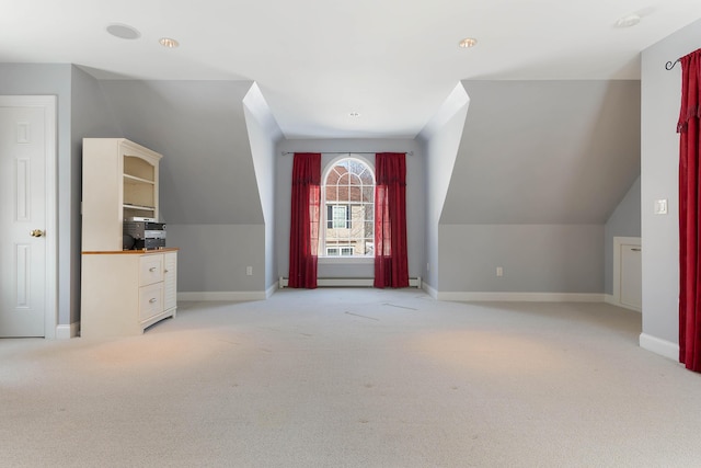 additional living space with light carpet, a baseboard radiator, baseboards, and lofted ceiling