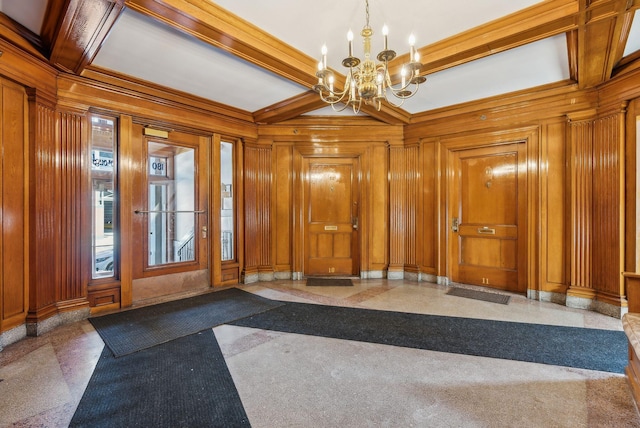 foyer entrance featuring a chandelier, ornamental molding, beam ceiling, and wooden walls