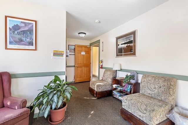 living area featuring dark carpet