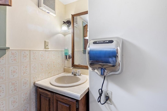 bathroom featuring tile walls, a wall mounted air conditioner, and vanity