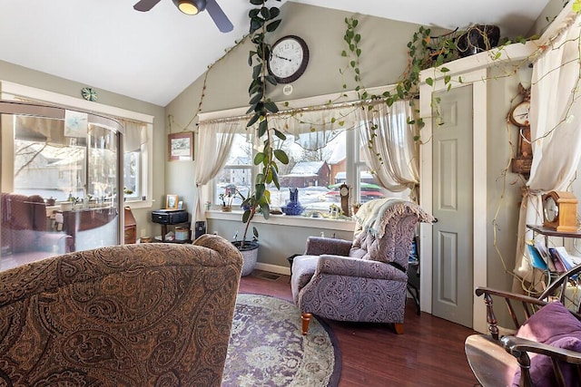 living area featuring dark hardwood / wood-style flooring, ceiling fan, and lofted ceiling