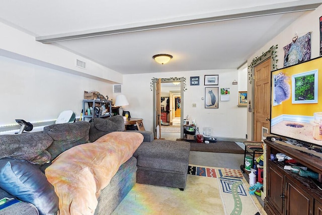 living room with beam ceiling and concrete floors