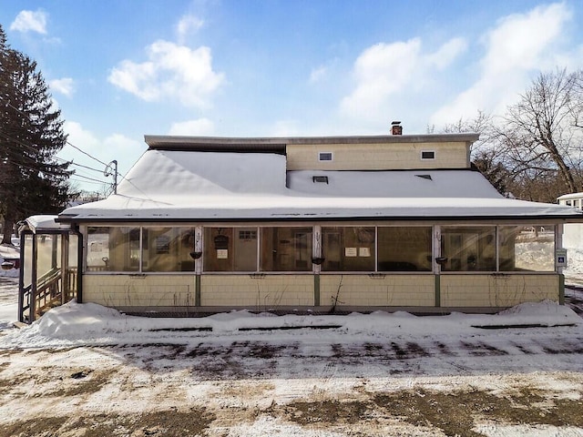 view of snow covered rear of property