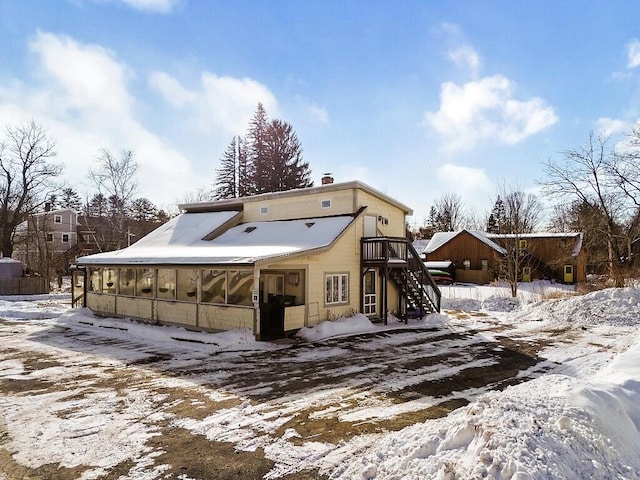 view of snow covered back of property