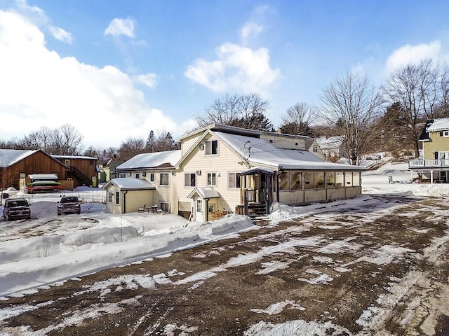 view of snow covered back of property