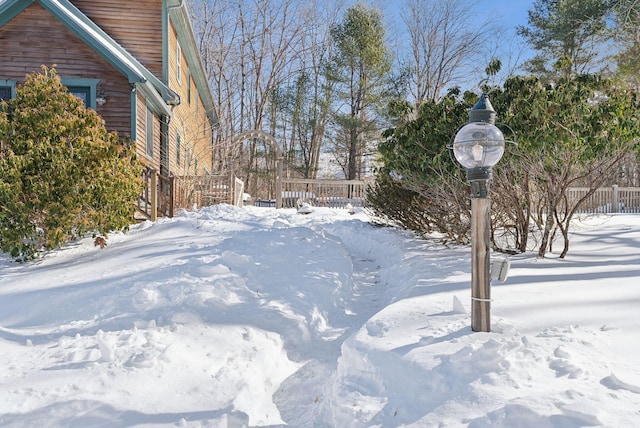 snowy yard with fence