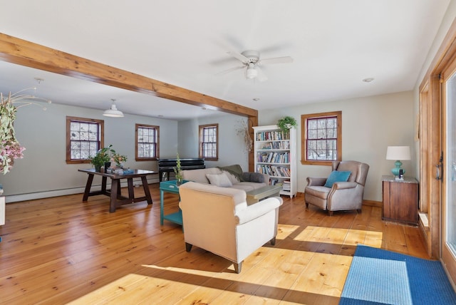 living room with beam ceiling, ceiling fan, light wood-style flooring, and baseboards