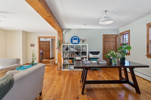 office with beamed ceiling and light wood-style floors