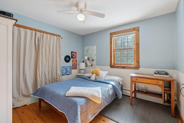 bedroom featuring a ceiling fan and a baseboard radiator