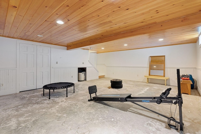 exercise room featuring a wainscoted wall, wood ceiling, and recessed lighting