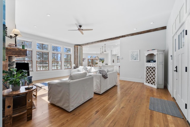 living room featuring recessed lighting, ceiling fan, light wood-style flooring, and baseboards