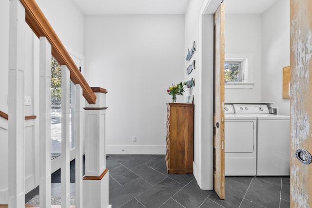 laundry room with baseboards, plenty of natural light, and washer and dryer