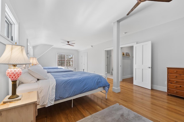 bedroom with ceiling fan, baseboards, wood finished floors, and ensuite bathroom