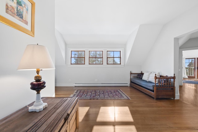 living area with lofted ceiling, dark wood-type flooring, and baseboard heating