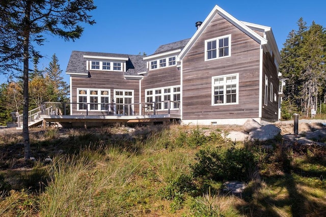 rear view of property featuring a wooden deck