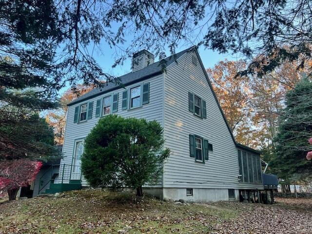 view of side of home featuring a sunroom