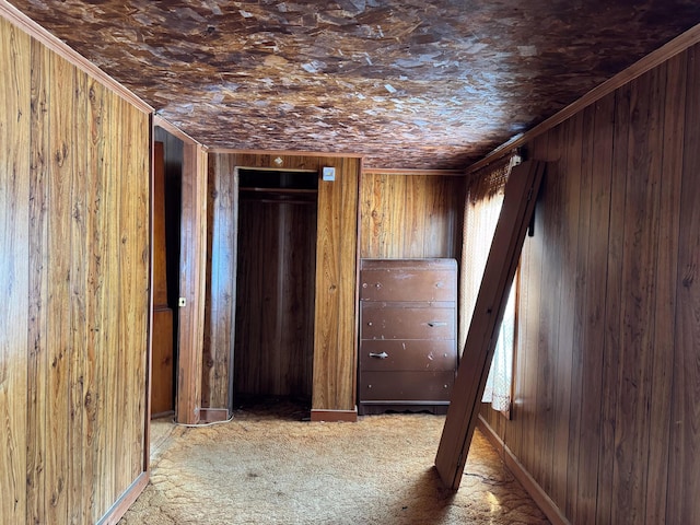 corridor featuring carpet floors and wooden walls