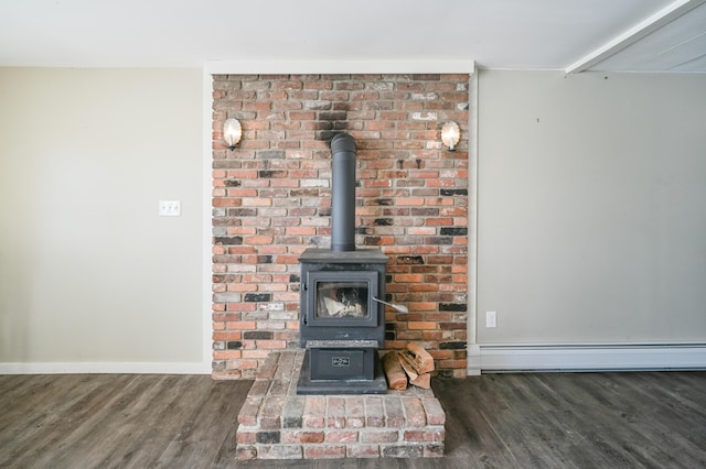 room details featuring a baseboard radiator, wood finished floors, a wood stove, and baseboards