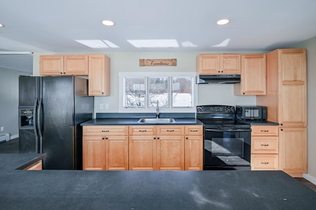 kitchen featuring dark countertops, recessed lighting, a sink, under cabinet range hood, and black appliances