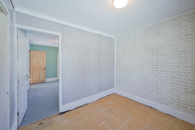 spare room with brick wall