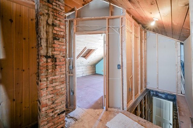 hall featuring vaulted ceiling