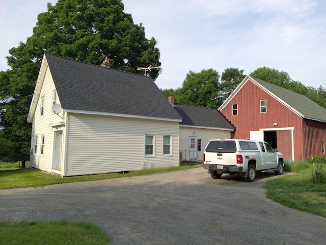 96 Exeter Rd, Garland, ME 04939 - view of front of home featuring asphalt driveway, a shingled roof, an outdoor structure, and a garage