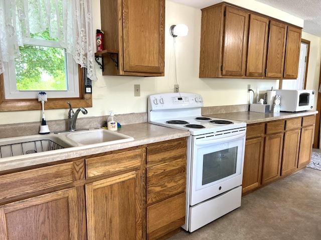 96 Exeter Rd, Garland, ME 04939 - kitchen featuring white appliances, brown cabinetry, a sink, and light countertops