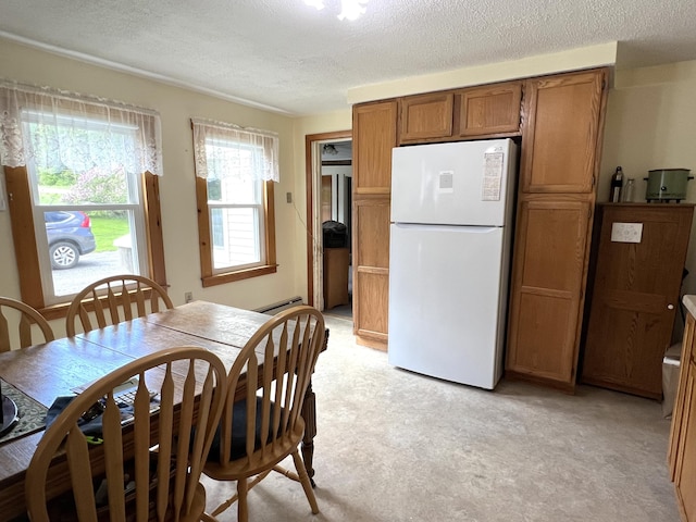 96 Exeter Rd, Garland, ME 04939 - dining room featuring light colored carpet, a textured ceiling, and baseboard heating