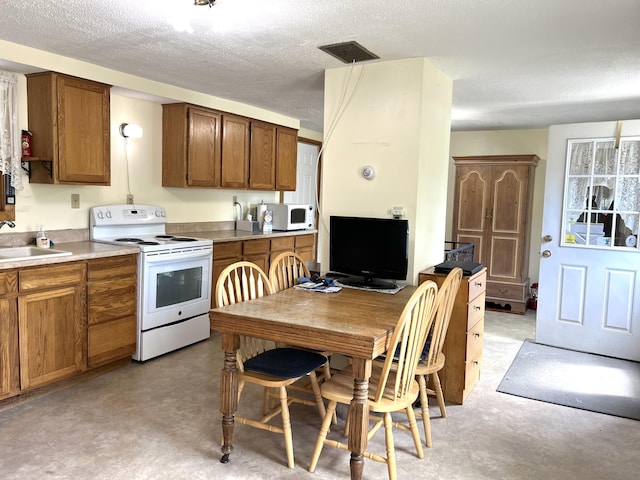 96 Exeter Rd, Garland, ME 04939 - kitchen featuring white appliances, a sink, brown cabinets, a textured ceiling, and light countertops