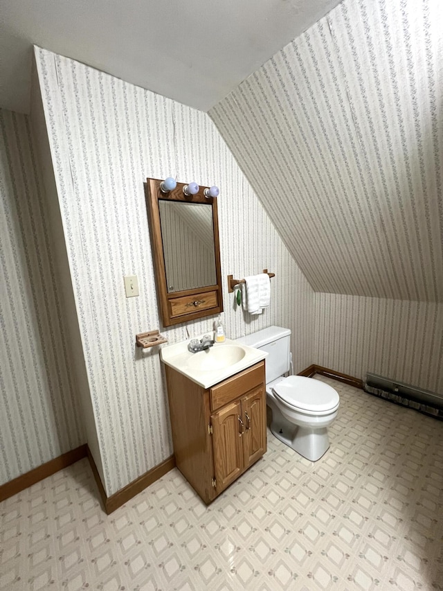 96 Exeter Rd, Garland, ME 04939 - bathroom with lofted ceiling, toilet, vanity, and baseboards