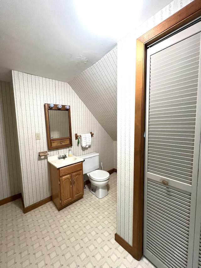 96 Exeter Rd, Garland, ME 04939 - half bath featuring vaulted ceiling, toilet, baseboards, vanity, and wallpapered walls