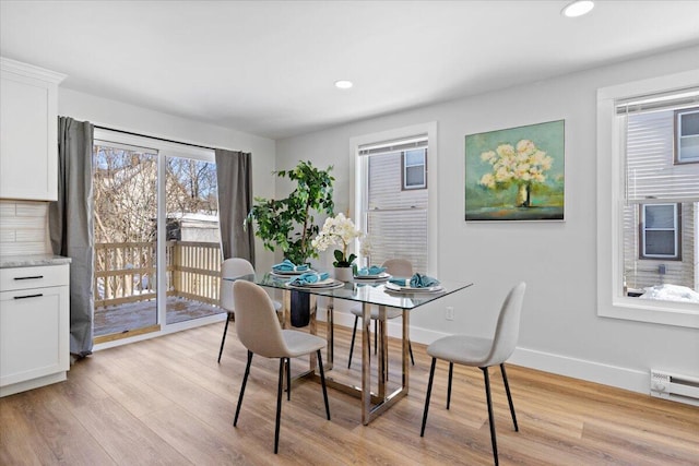 dining room featuring light wood-style floors, recessed lighting, baseboards, and a baseboard radiator