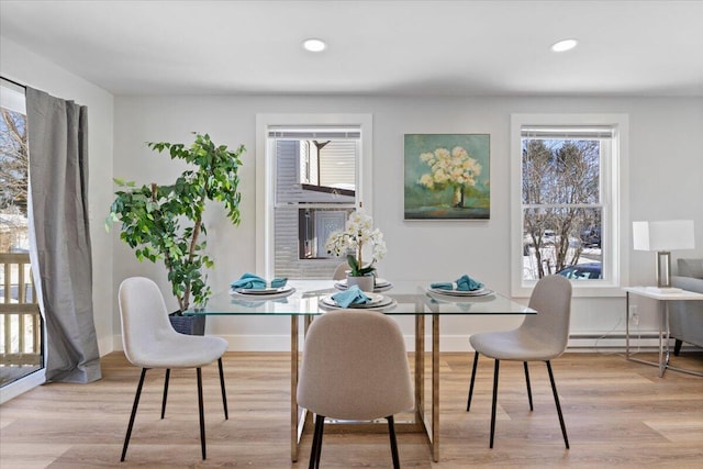 dining space featuring baseboards, baseboard heating, recessed lighting, and light wood-style floors