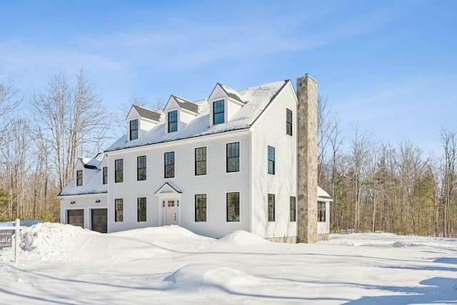 view of front of house featuring a garage and a chimney