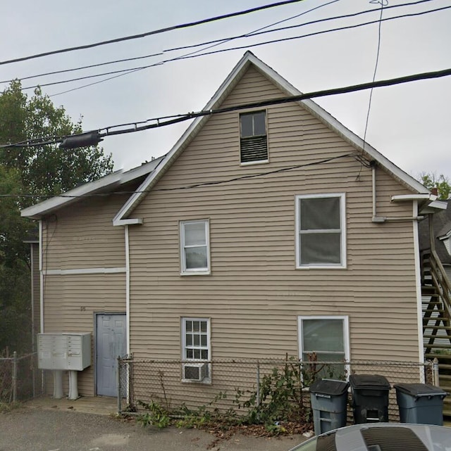 view of side of home featuring fence