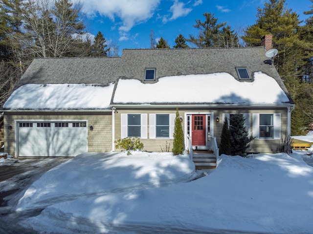 view of front of home featuring a garage, driveway, and a chimney