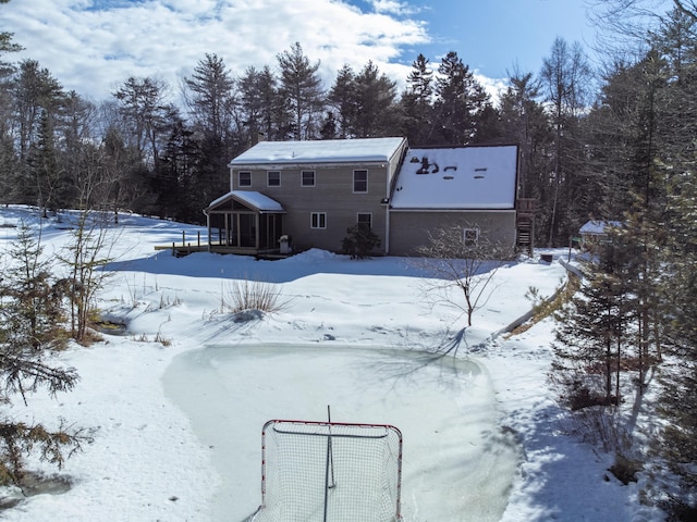 view of snow covered back of property