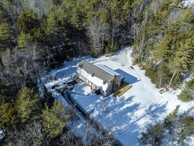 snowy aerial view featuring a view of trees