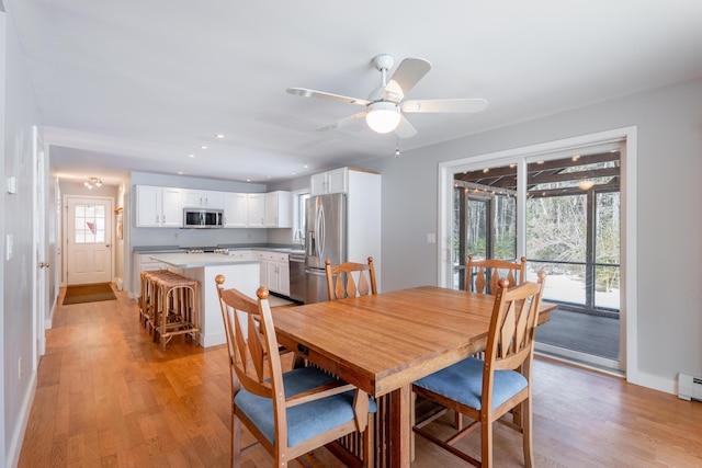 dining area featuring light wood-style flooring, baseboards, a ceiling fan, and recessed lighting