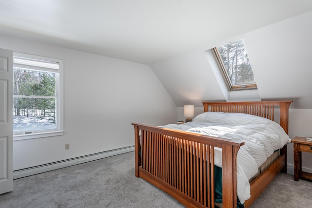 bedroom with lofted ceiling with skylight, carpet, and a baseboard heating unit