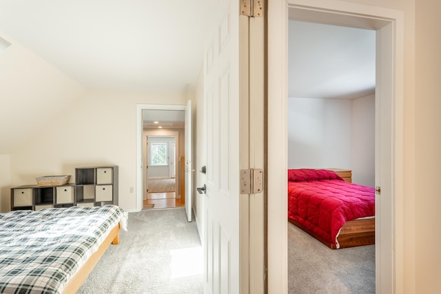 bedroom featuring lofted ceiling and carpet flooring