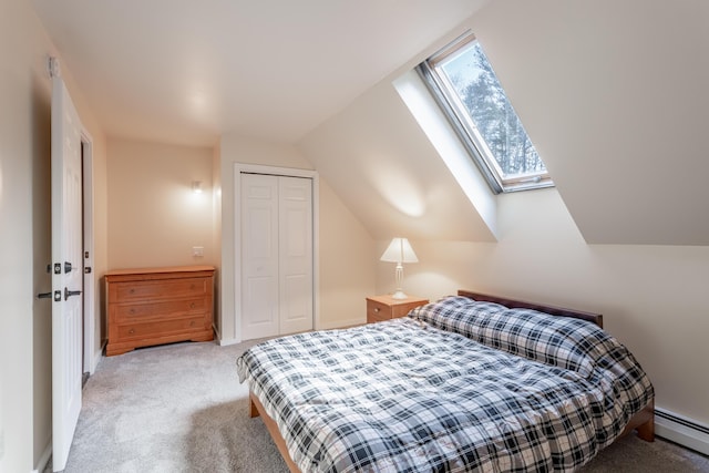 bedroom featuring light carpet, lofted ceiling with skylight, baseboard heating, and a closet