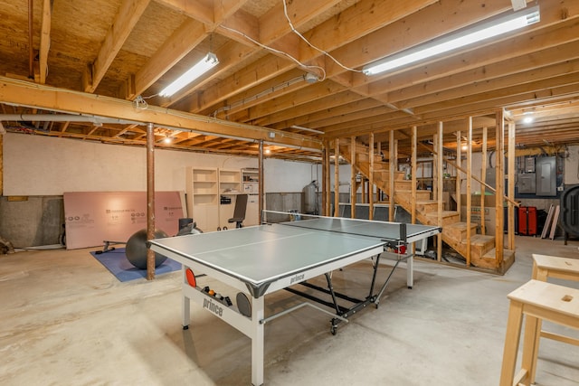 playroom featuring electric panel and unfinished concrete floors