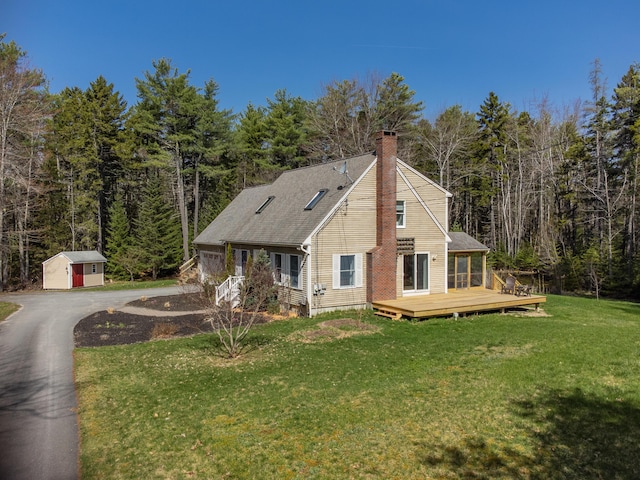 27 Libby Ln, Brunswick, ME 04011 - view of side of property featuring a chimney, a yard, an outbuilding, a shed, and a deck