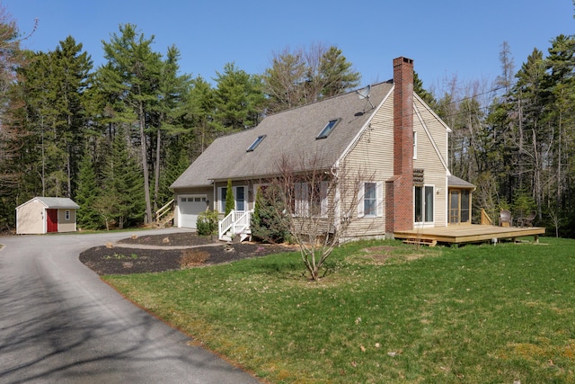 27 Libby Ln, Brunswick, ME 04011 - cape cod house featuring a garage, a chimney, a front lawn, driveway, and roof with shingles