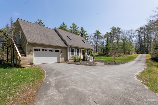 27 Libby Ln, Brunswick, ME 04011 - view of front of home with a front yard, a shingled roof, a chimney, and driveway