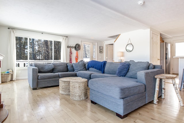 living room with light wood-style floors and a textured ceiling