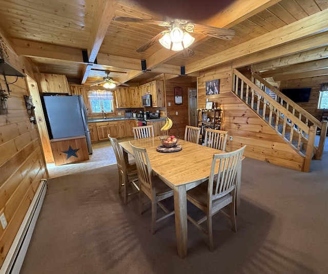 9 Ledge Dr, Greenville, ME 04441 - dining space featuring baseboard heating, wood walls, wood ceiling, and light carpet