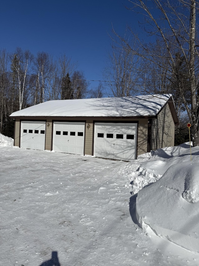 9 Ledge Dr, Greenville, ME 04441 - snow covered garage with a detached garage