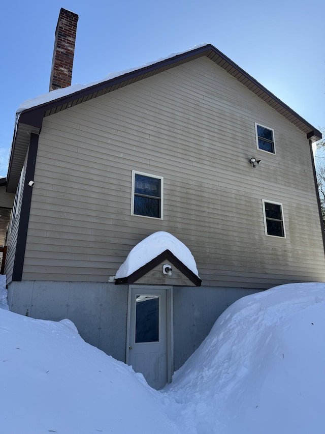 9 Ledge Dr, Greenville, ME 04441 - view of snow covered exterior with a chimney